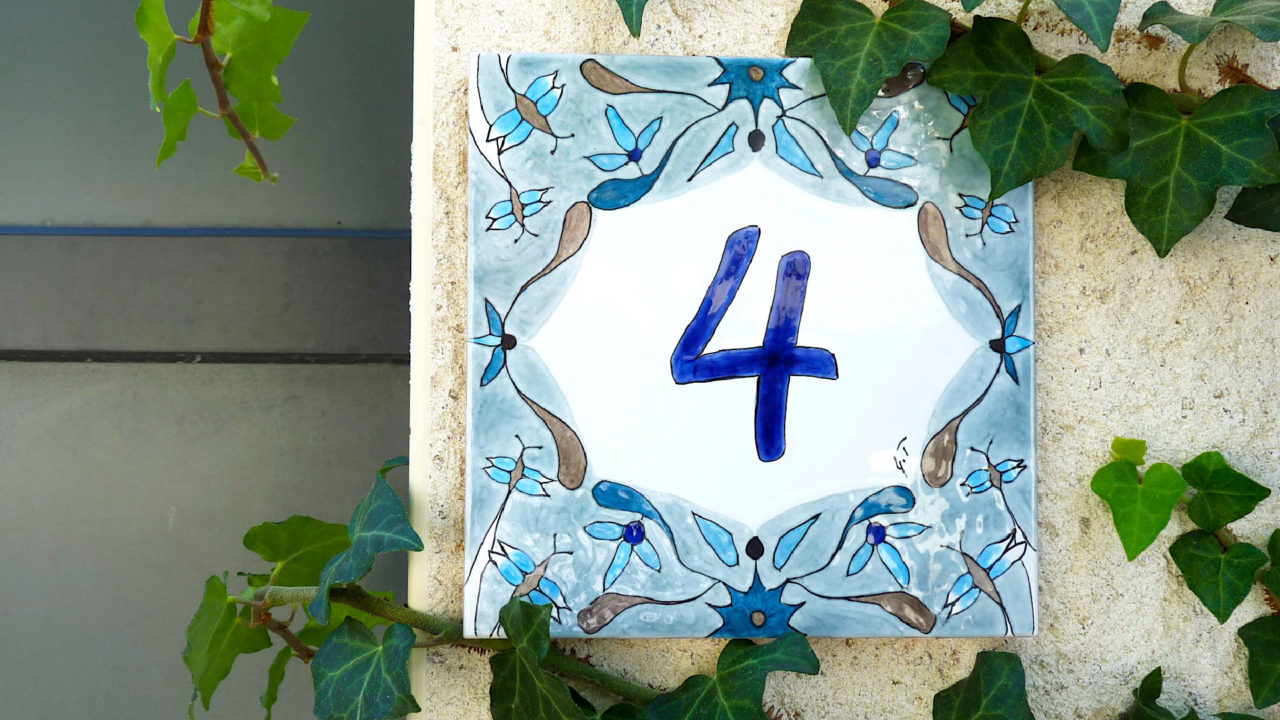 Numéro de maison céramique bleu motifs papillons et fleurs sur mur blanc maison avec lierres numéro d'exemple 4